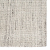 An ivory and gray area rug with a handwoven texture.