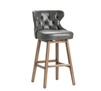 Gray cushioned bar stool with wooden legs on a white background