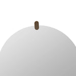 Round white object with a brown handle on a white background