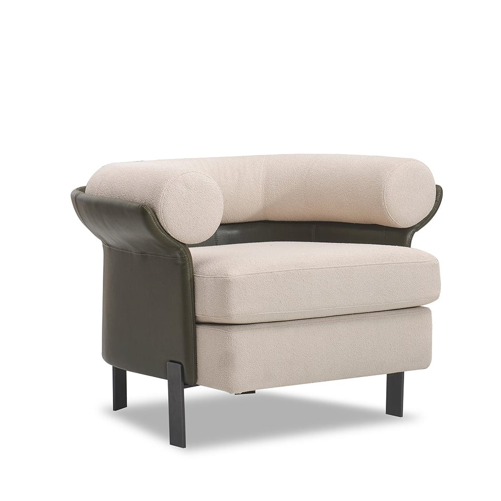 Beige armchair with black leather accents on a white background