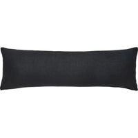 A black rectangular throw pillow with a shearling exterior, designed to fit a standard size pillowcase.