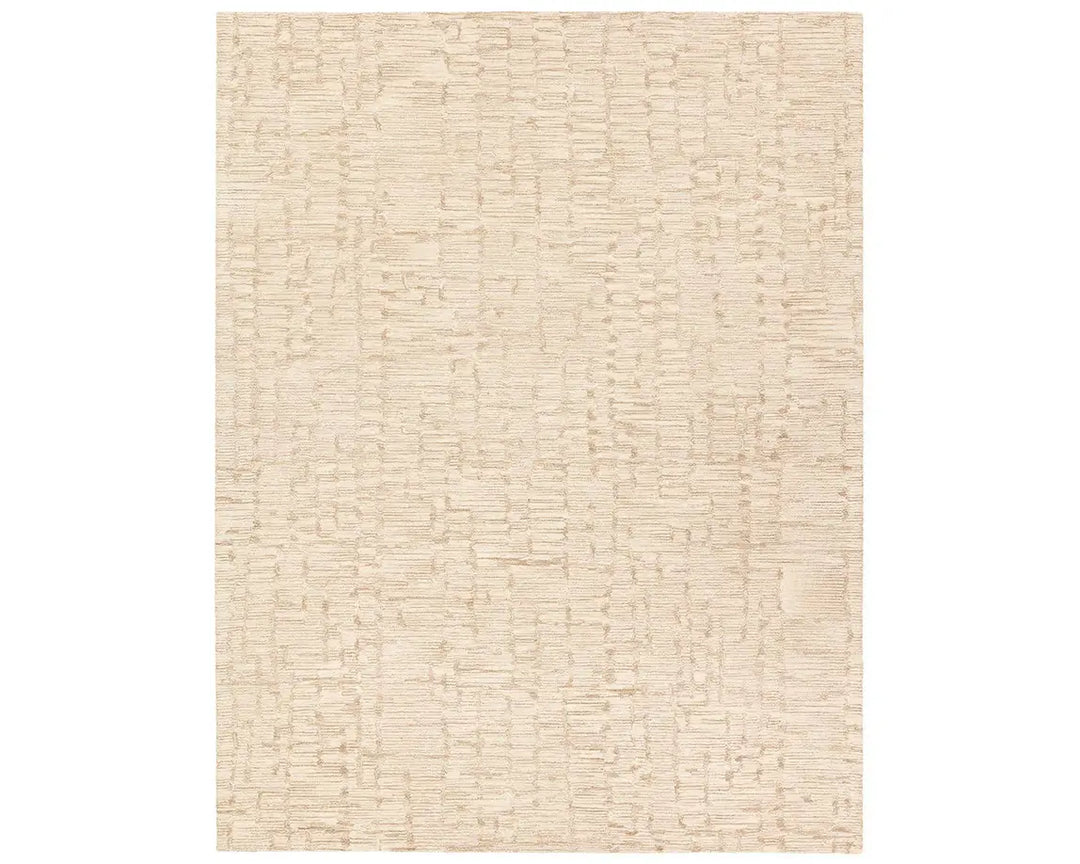 A beige wool area rug with a hand-tufted texture.