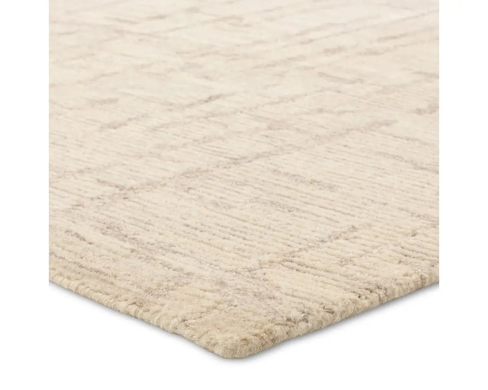 Light beige wool area rug with a hand-tufted texture