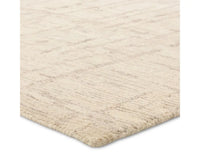Light beige wool area rug with a hand-tufted texture