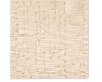A beige wool area rug with a hand-tufted texture.