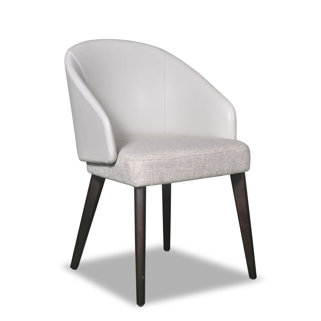 A white upholstered dining chair with a full back and seat, featuring dark brown wooden legs.