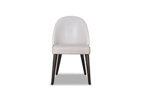 A white upholstered dining chair with a modern design, featuring a full backrest and padded seat, on four wooden legs.