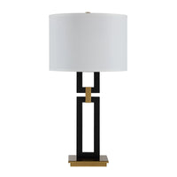 Table lamp with a white shade, black and gold base on a white background