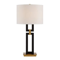 Table lamp with a black and gold base and white shade on a white background