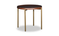 Small round table with dark top and brass legs on a white background