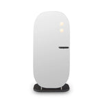White cylindrical device on a black stand against a white background