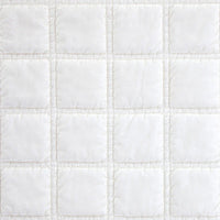 Close-up of a white quilted fabric texture