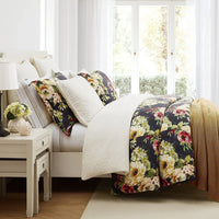 Floral-patterned comforter on a bed in a bright bedroom