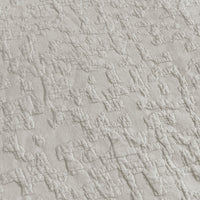 Close-up of textured light gray fabric with a subtle pattern