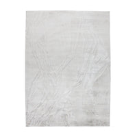 A power loomed Mila Area Rug in off white with a polypropylene and polyester construction and jute backing.