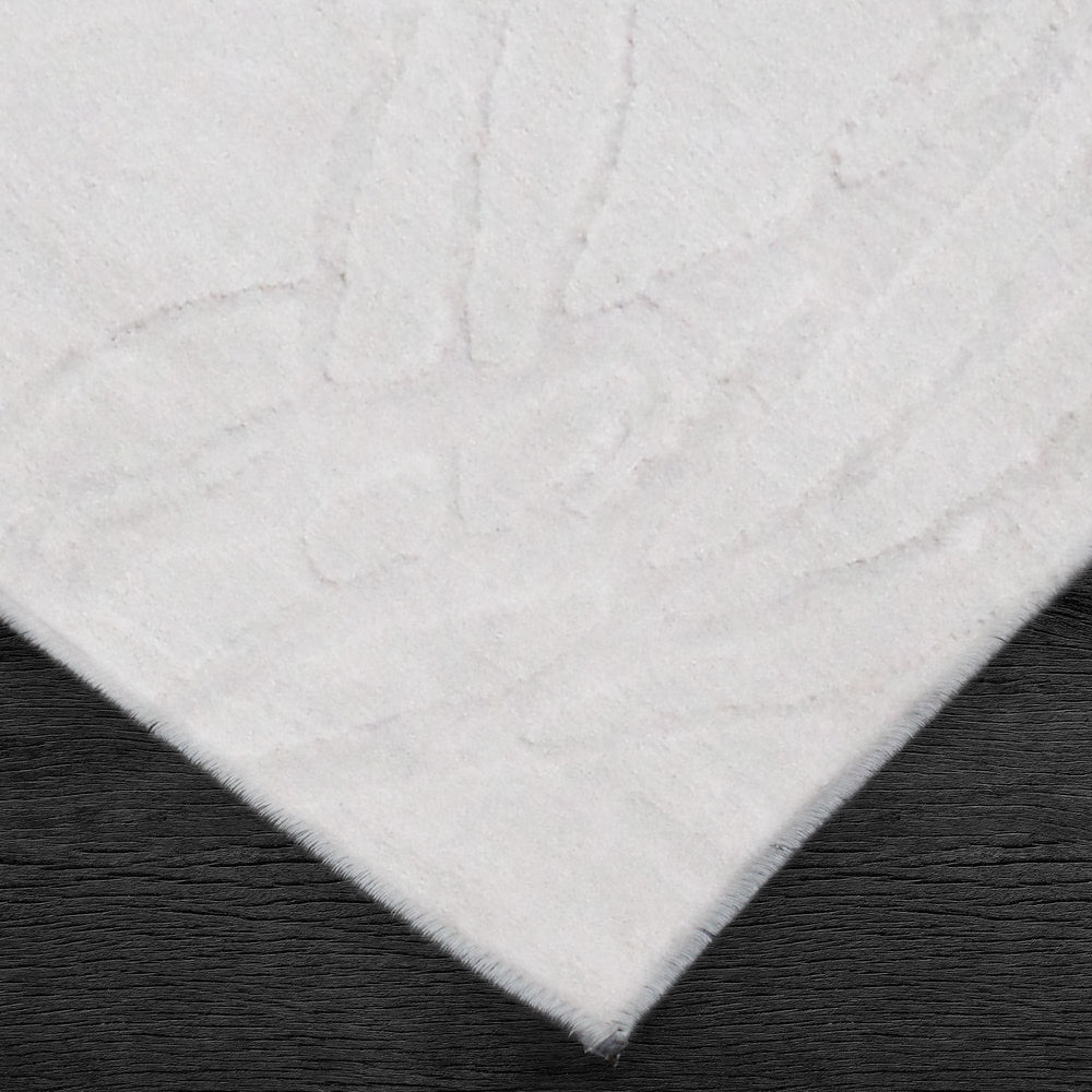 A power loomed Mila Area Rug in off white with a polypropylene and polyester construction and jute backing.
