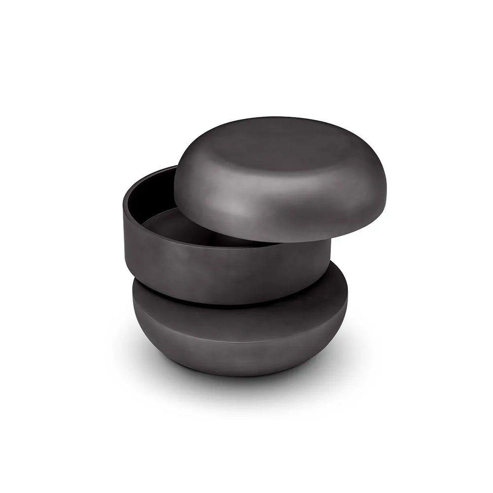 Set of three black ceramic bowls stacked on a white background