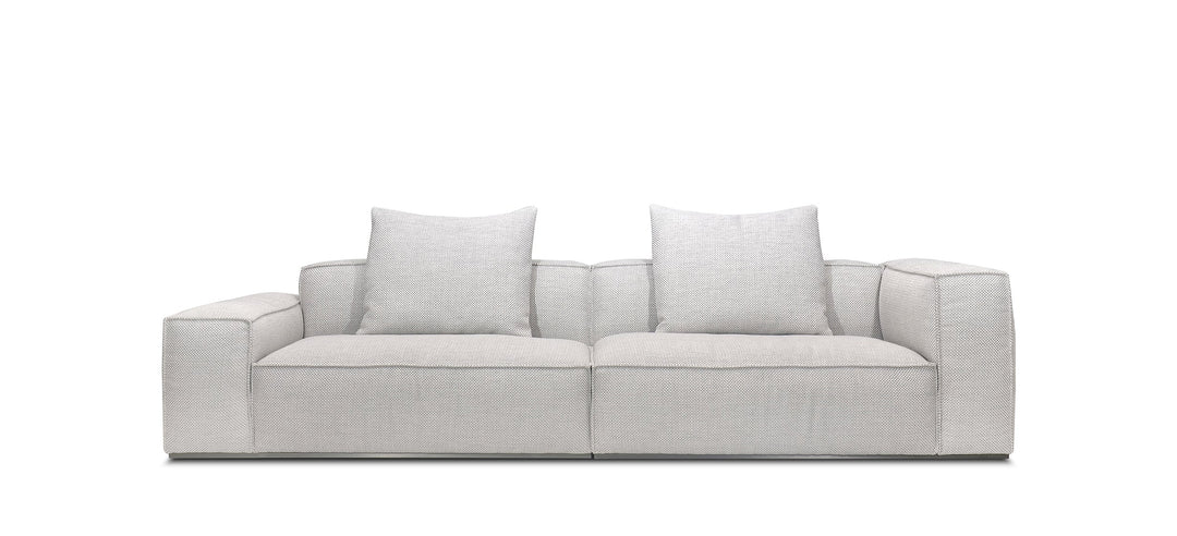 A beige Monica sofa with a fabric cover, cushioned backrest, and a modern design, measuring 118 inches in width.