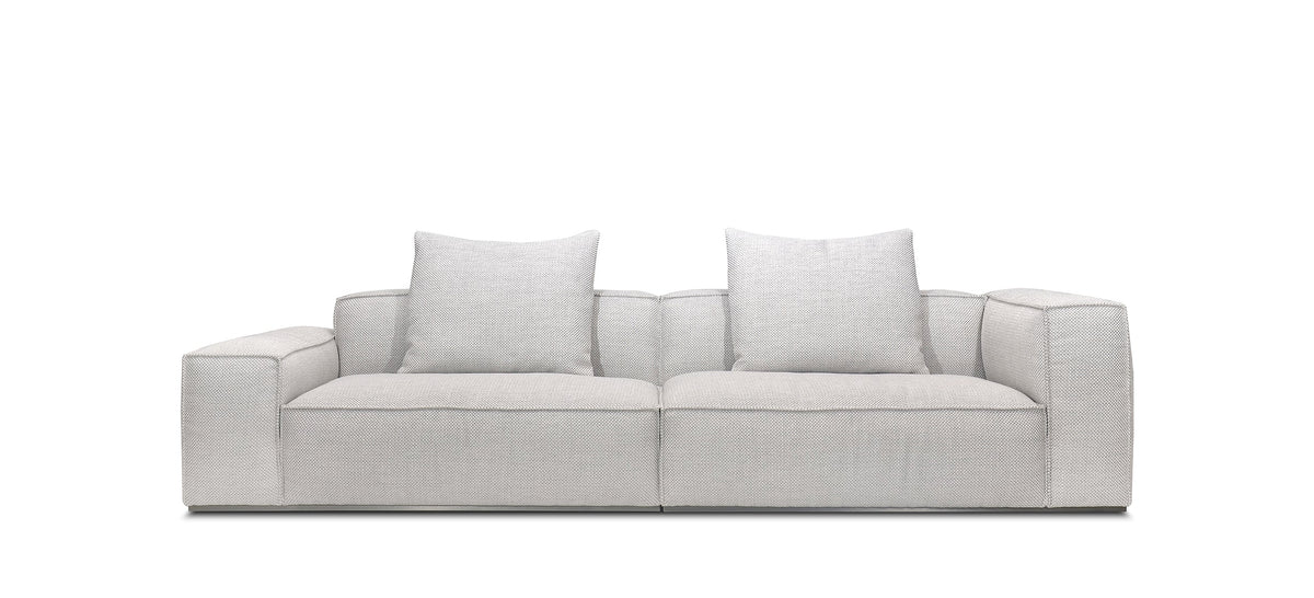 A beige Monica sofa with a fabric cover, cushioned backrest, and a modern design, measuring 118 inches in width.