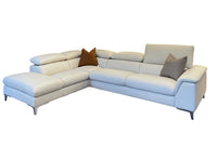 White sectional sofa with brown and gray cushions on a white background