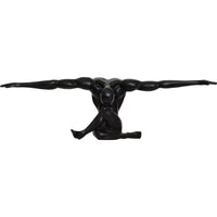 A black matte statue of a figure with arms outstretched, standing on a base, with a matte finish.