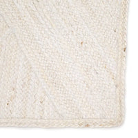 Close-up of a woven beige rug with a textured pattern.