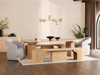 Modern dining room with wooden table and chairs, decorative elements, and a chandelier.