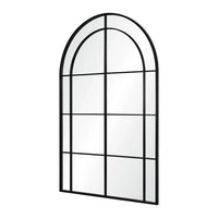 A large full-length mirror with an arched frame and grid-like iron details.