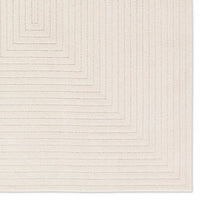 Textured beige area rug with geometric pattern
