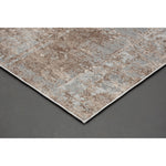 A rectangular area rug featuring a subtle pattern with muted brown and grey tones, suitable for contemporary living or bedroom spaces.