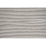 A power loomed area rug in light cream and grey colors with a polypropylene pile and jute backing.