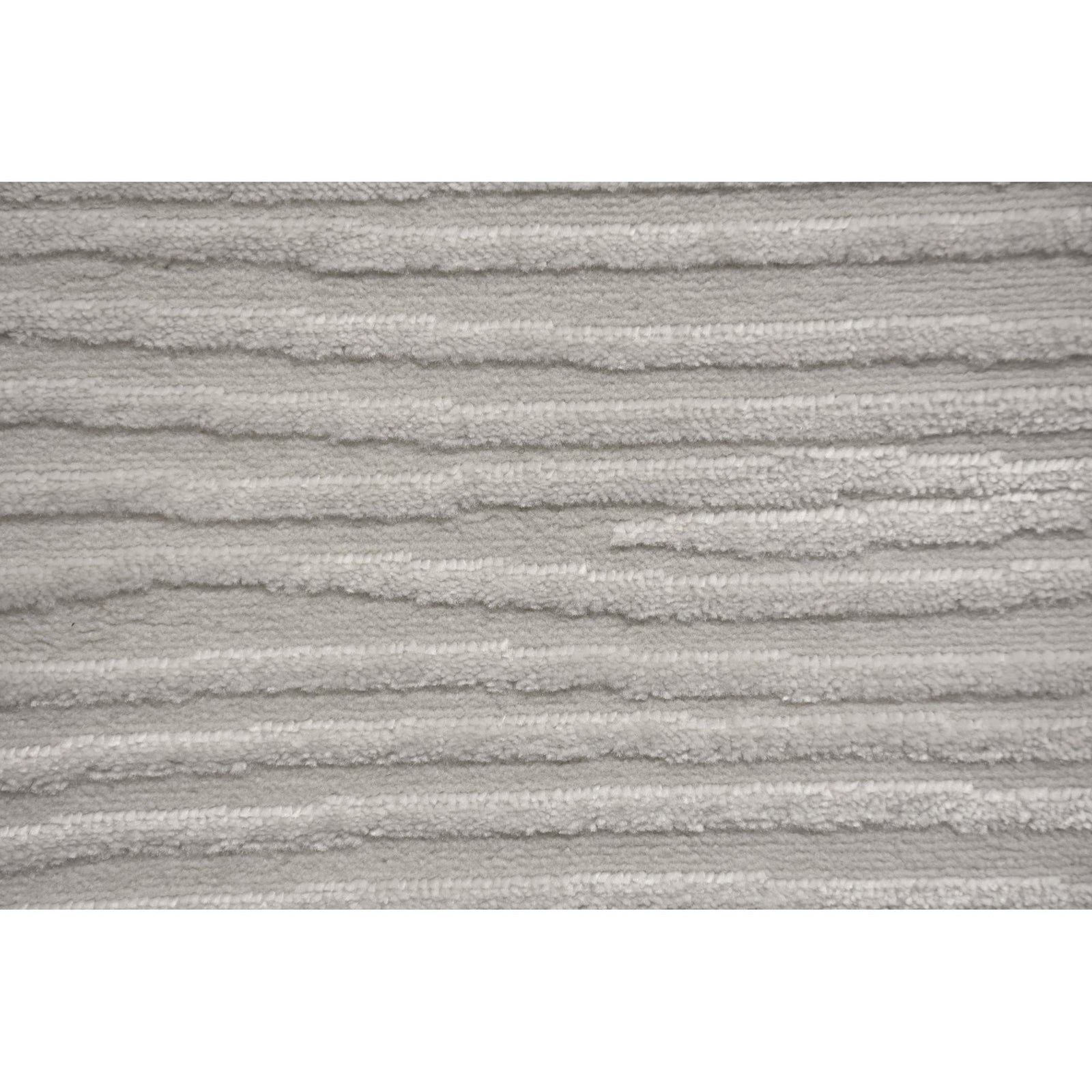 A power loomed area rug in light cream and grey colors with a polypropylene pile and jute backing.