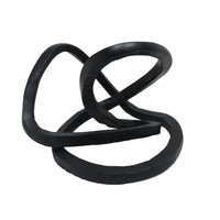 A black ribbon accent decor with an abstract, twisted shape.