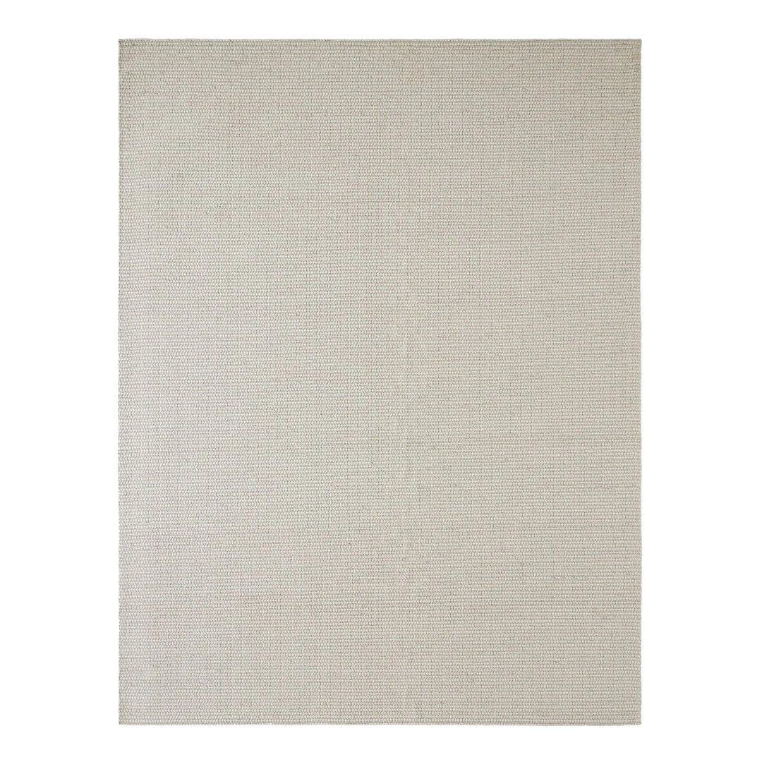 Beige area rug on a white background