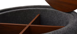 A gray fabric ottoman with a round top and a cylindrical body, placed against a white background.