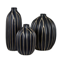 A set of three black vases with vertical golden stripes.