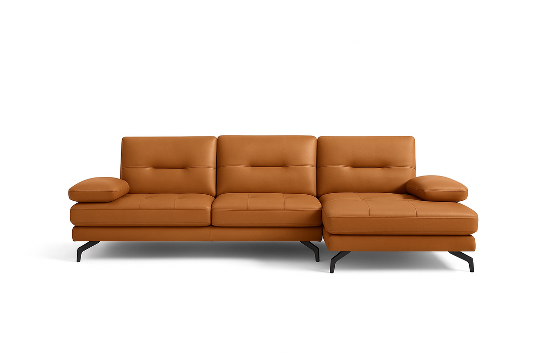 A tan-colored sectional sofa with a chaise on the right side, featuring a modern design with visible seat and back cushions.