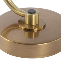 Close-up of a gold metal object with a handle on a white background