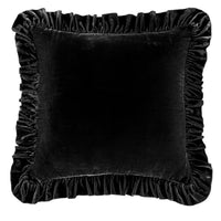 Black velvet pillow with ruffled edges on a white background