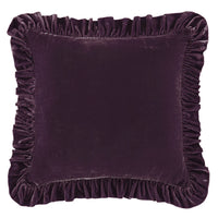 Purple velvet pillow with ruffled edges on a white background