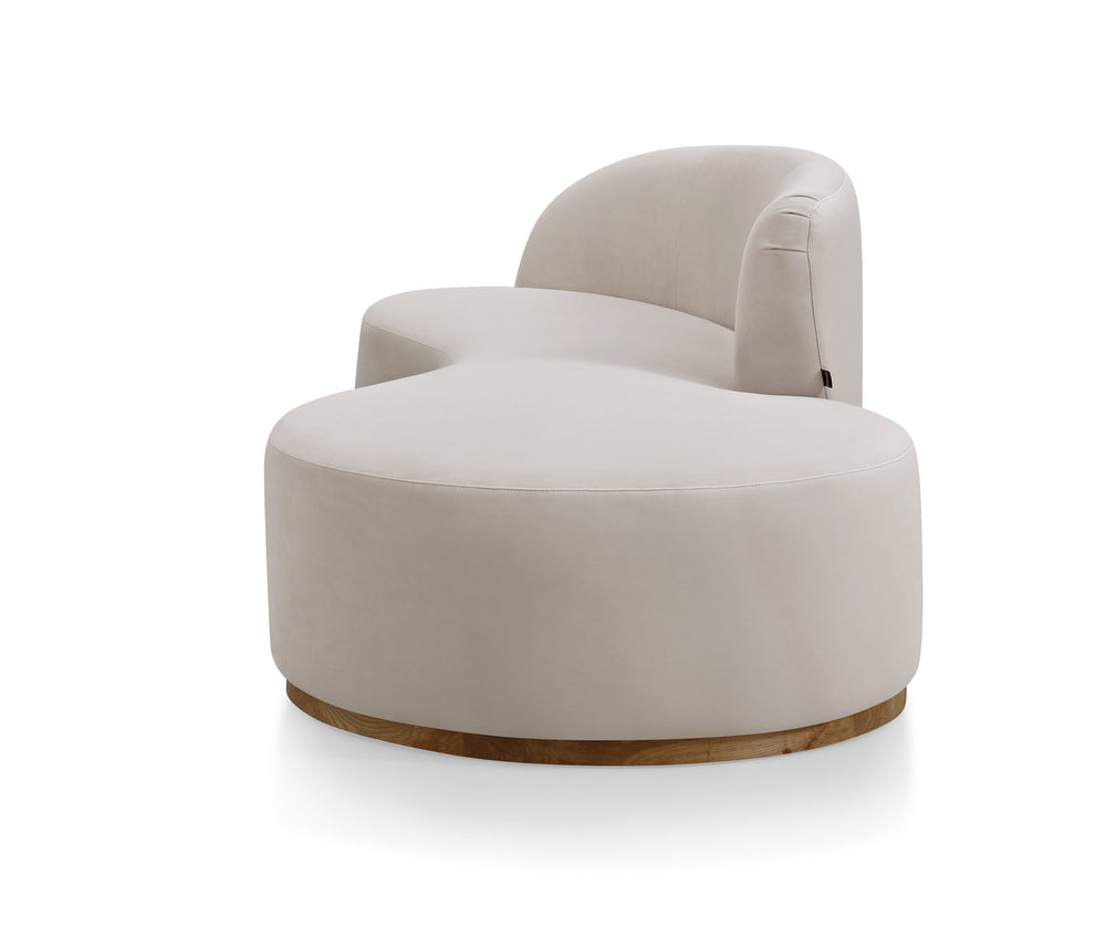 A beige curved sofa with a modern design, featuring a deep seat and a smooth, continuous curve.