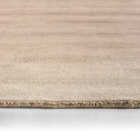Beige rug with a textured pattern on a white background