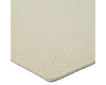 A beige area rug with a textured weave, laid out flat.