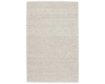 A beige, solid color wool area rug handwoven with a visible texture.