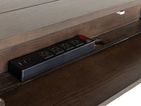 Power strip with multiple outlets embedded in a wooden shelf.