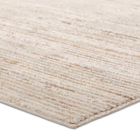 A power loomed area rug with beige and brown tones.