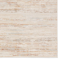 A power loomed area rug with beige and brown tones.