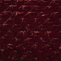 Close-up of a textured dark red fabric surface