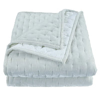 Folded light gray weighted blanket on a white background