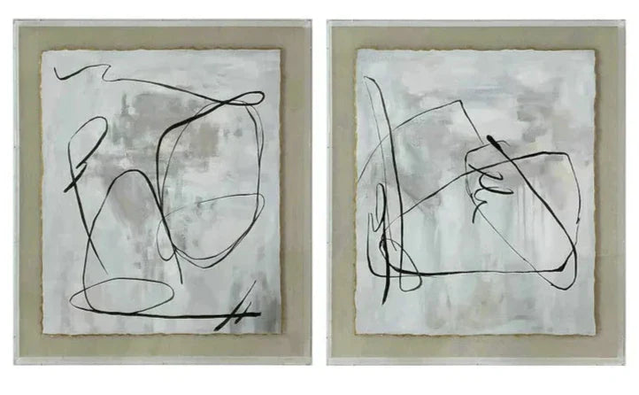 Two abstract wall art pieces with black line designs on a light background